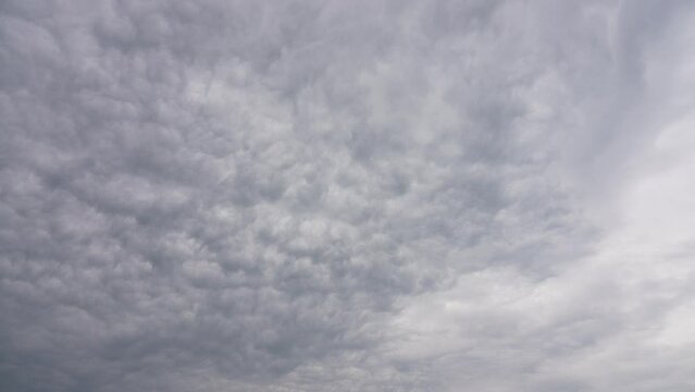 4k stock video time lapse of beautiful light blue and white cloudy sky. Natural abstract textured background with flying white rainy clouds, isoated on blue bright spring or summer sky backdrop