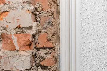 Old brick fragment of unfinished construction repair and reconstruction of the wall close-up