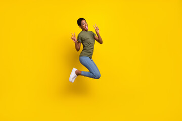 Fototapeta na wymiar Full length portrait of friendly crazy person jump two hands demonstrate v-sign isolated on yellow color background