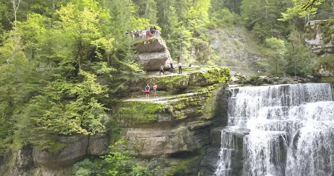 Waterfall in the doubs river, Neuch&acirc;tel, Switzerland, people want to jump, zoom in drone aerial shot