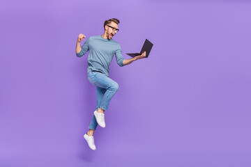 Photo of busy lucky guy wear grey shirt spectacles jumping high writing modern device isolated...