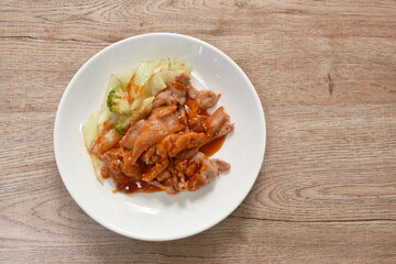 Korean fried slice pork with cabbage dressing spicy barbecue sauce on plate 