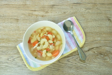 boiled macaroni chicken with potato soup on bowl
