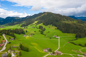 Aerial view of fields and landscape with mountains in the center of Switzerland in the Berner Oberland