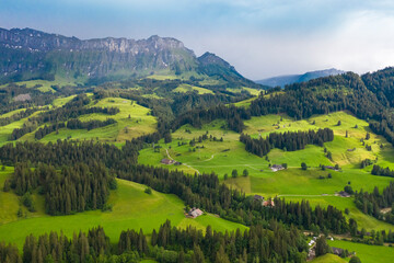 Fototapeta na wymiar Aerial view of fields and landscape with mountains in the center of Switzerland in the Berner Oberland