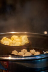 Cantonese morning tea dim sum is being cooked in a steamer in a Chinese kitchen