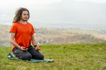 Young man meditating yoga on the mountain. Relax and calm