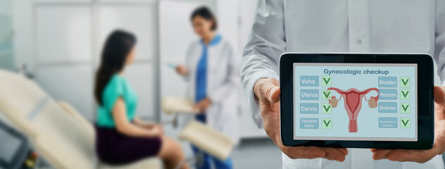 Gynecological check-up, concept. Gynecologist holding tablet with results of gynecological exam, on...