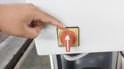 a man is showing the position of turning on the rotary switch.