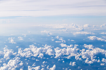 Fototapeta premium Aerial view of Fluffy clouds Top view from airplane window, Nature background.