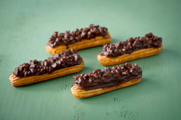 Eclair cakes with a beautiful flower background and tea cup, and great background