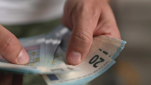 hand counting 20 euros banknotes
