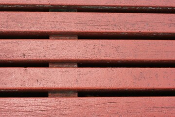 red wooden slats on a bench