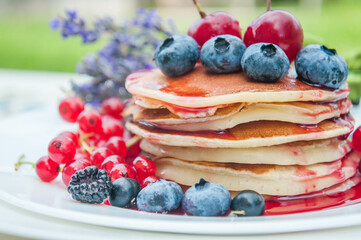 Pancakes with berries. Breakfast in the garden.