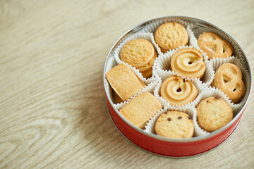 Top view tasty danish butter cookies in a tin box , set of crispy shortbread biscuits, baked pastry, sweet food, space for text.