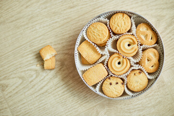 Top view tasty danish butter cookies in a tin box , set of crispy shortbread biscuits, baked pastry, sweet food, space for text.