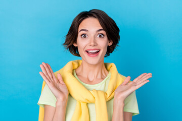 Photo of impressed millennial brunette lady wear green t-shirt jumper isolated on blue color background