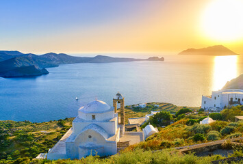 Beautiful view of Mediterranean islands at sunset. Greek Orthodox church facing sun. Low sun, sun...