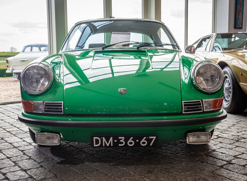 Brummen, Province Gelderland, The Netherlands, 21.03.2022, Front view of retro car Porsche 911 E Targa from 1970 in green color