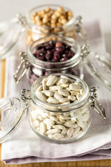 Three Jars of Dried lLegume White Red Kidney Beans and Chickpeas on Gray Background Dried for Storage and Preservation Long Shelf Life Nutritional Food Vertical
