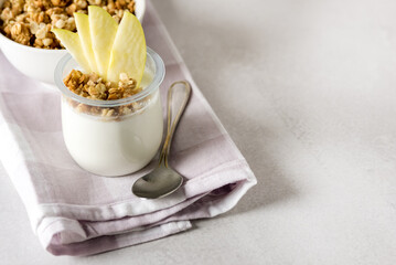 Homemade Yougurt with Granola Decorated with Apple Healthy Diet Breakfast Napkin Spoon Gray Background Horizontal