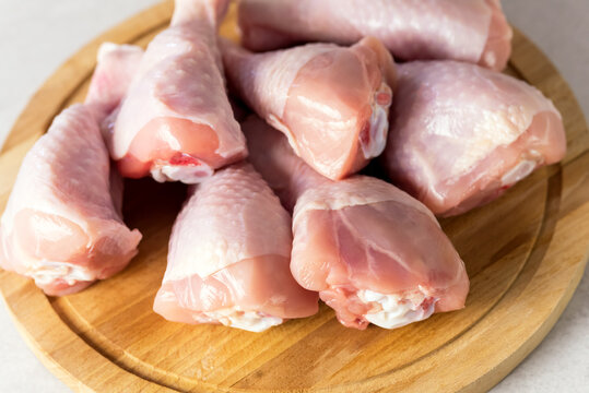 Farm Raw Uncooked Chicken Legs on Wooden Board Meat For Cooking Above Horizontal