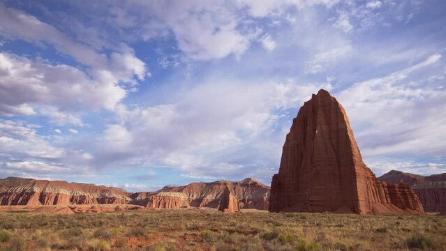 Temple of the Sun and the Moon in Capitol Reef National Park Utah as clouds move through the sky.