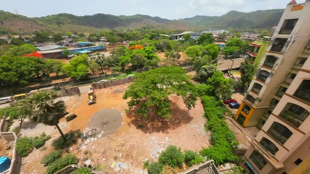 timelaps of moving shadow of cloudes over mountains construction site and budlings  India Mumbai