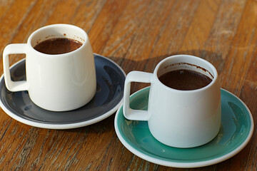 Starting day with coffee. two cups of espresso on wooden background with copy space