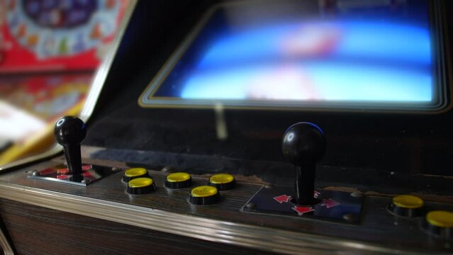 A vintage arcade machine cabinet with a retro fighting video game