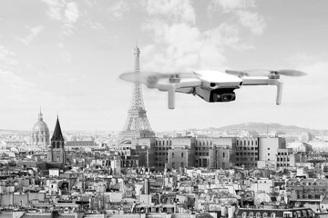Drone with 4k digital camera flying over Paris city with Eiffel tower at the background in Paris, France. Technology background