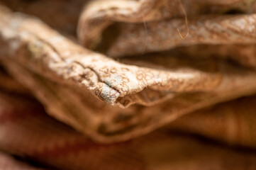 Pieces of fabric with different patterns, stacked. Close-up, selective focus