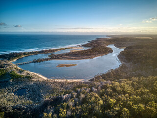 Fototapeta na wymiar Aerial view in the late afternoon over the mouth of the Betka River in eastern Victoria, Australia, December 2020