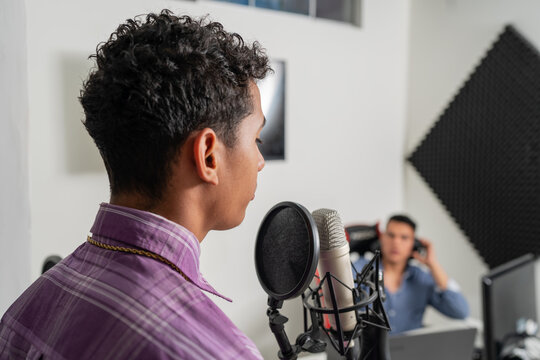 Singer Recording Voice In Mic At Music Studio