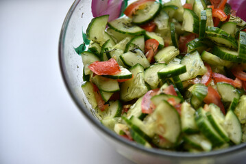 Cucumber and tomato salad with dill in a plate