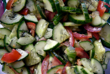Cucumber and tomato salad with dill in a plate
