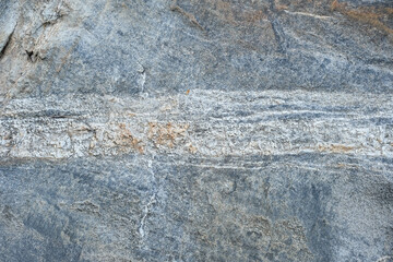 Close-up texture of a natural river bank stone wall in a mountain forest in northern Thailand. Stone and ecology concept.