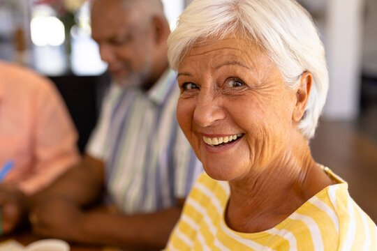 Close-up portrait of cheerful biracial senior woman with african american man in nursing home