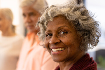 Close-up portrait of cheerful african american senior woman with multiracial friends in nursing home - Powered by Adobe