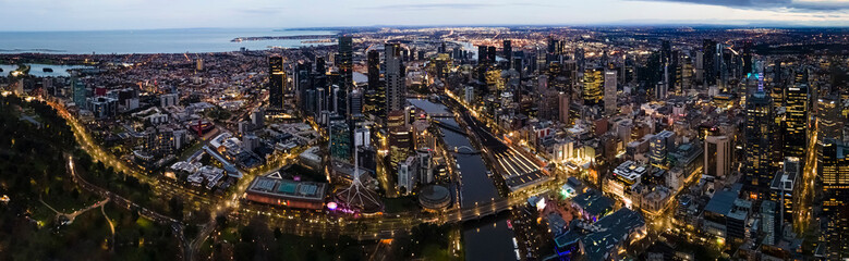 Fototapeta premium Panoramic aerial drone view of Melbourne City, Victoria, Australia looking in the direction of Port Phillip above Yarra River in the early morning 