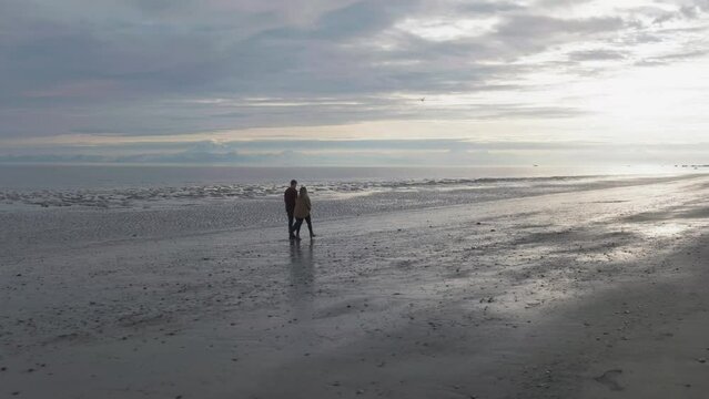 Couple walking on beach in Kenai, Alaska
