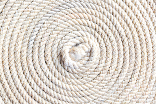 Macro rope texture,Super close up of a thick rope in shape of a spiral,Photo of an old vintage rope. Natural warm light 