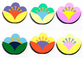 Set of paper flowers of different colors on a white background.