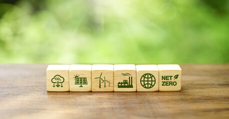 Net-zero emissions in 2050. Save earth and environment, and carbon neutral. Wooden cubes with eco-friendly icons on the natural background. World Earth Day concept.  