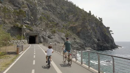  Italy , Liguria , June 2022 - Going bike from  Levanto Bonassola Framura cycle  pedestrian path - old galleries tunnels  in the rock by the sea - tourist attraction in the Cinque Terre © andrea