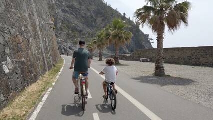 Italy , Liguria , June 2022 - Going bike from  Levanto Bonassola Framura cycle  pedestrian path - old galleries tunnels  in the rock by the sea - tourist attraction in the Cinque Terre