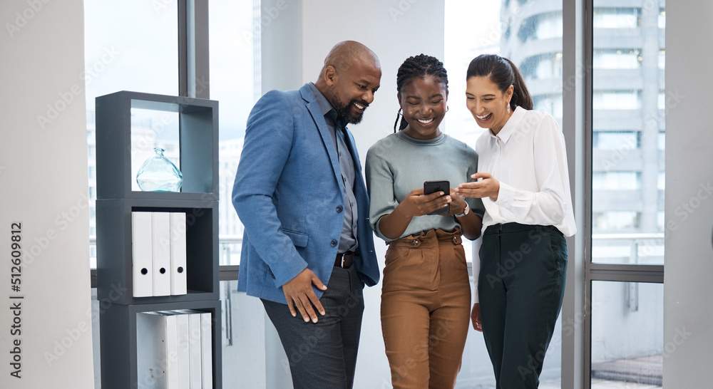 Poster Sharing in a connection. Shot of a group of businesspeople using a cellphone together in an office.