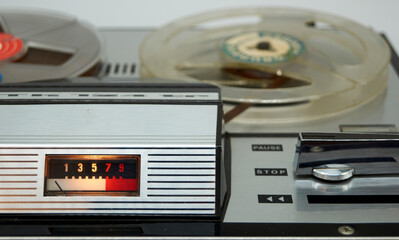 Fototapeta premium A vintage reel-to-reel tape recorder with a vu meter and a large switch from the seventies