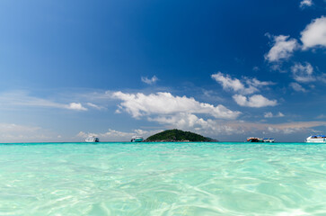 Speed boat on clear sea with white cloudy and blue sky at Similan Island, phang-nga Thailand