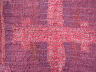 crinkled surface of back side of red silk scarf